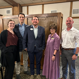 Five bankers gather for a photo. Smiles all around.