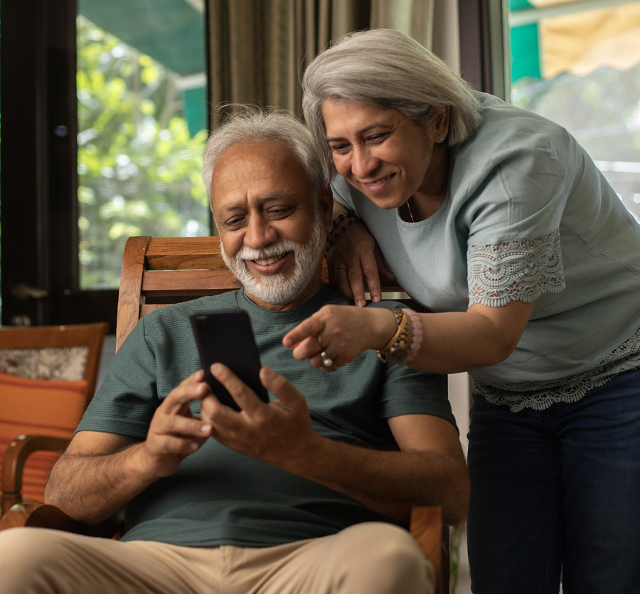 Mature couple looking at a mobile phone
